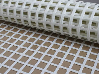 A roll of white color steel plastic composite mine supporting mesh on the ground.