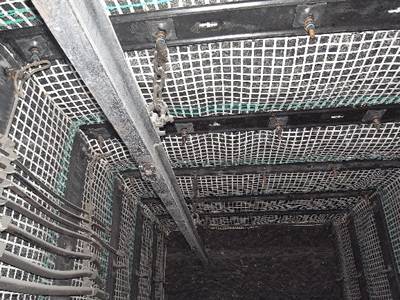 White color steel and plastic composite mine supporting mesh is covering the mine roadway roof and sidewall.