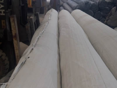 Several rolls of composite mine supporting mesh in woven bag package in the warehouse.