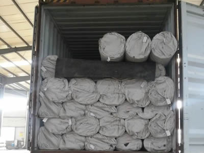 Several rolls of composite mine supporting mesh in woven bag package in the container.