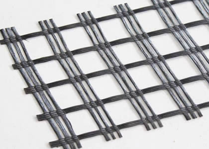 A piece of fiberglass geogrid on a light  gray background.