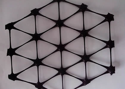 A piece of hexagonal triaxial geogrid on a white background.