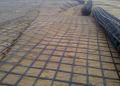 Many rolls of steel plastic geogrids are spreading on the ground.