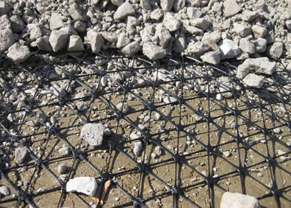 A piece of triaxial geogrid under gravel.